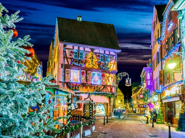 Colmar Christmas market at night, illuminated wooden chalets and a decorated tree